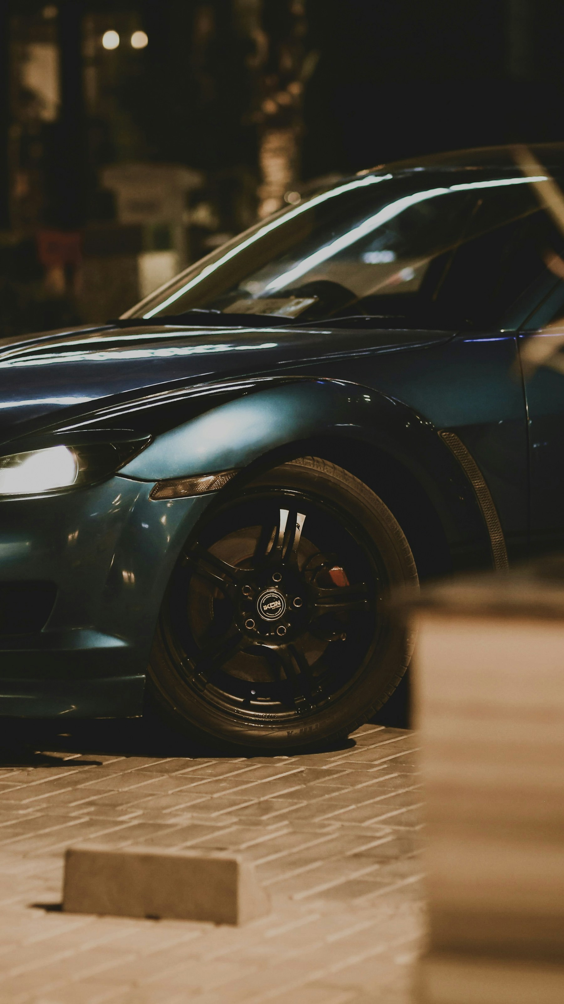 Dark performance car in an editorial street scene