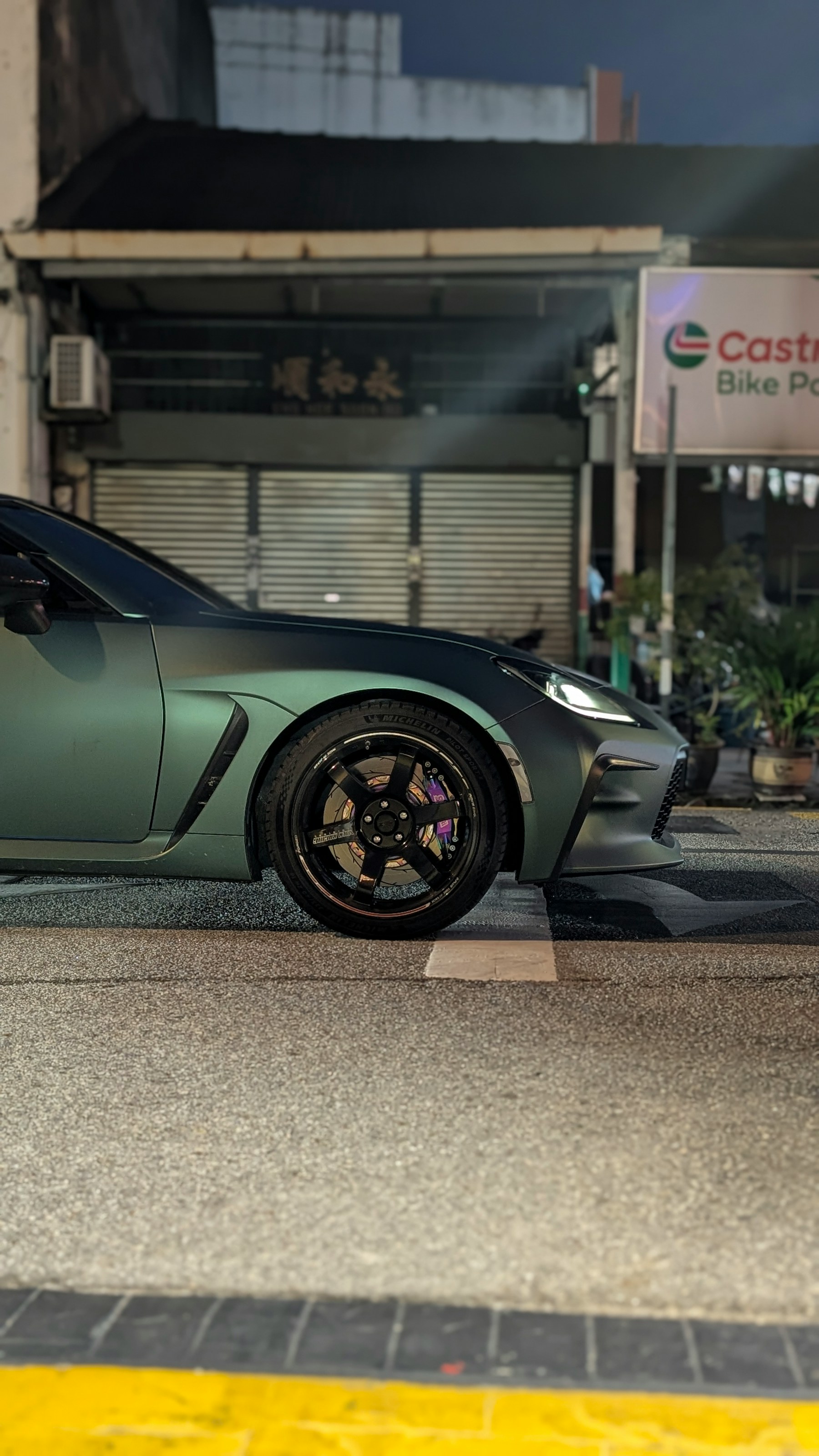 Sports car framed in a vertical street scene
